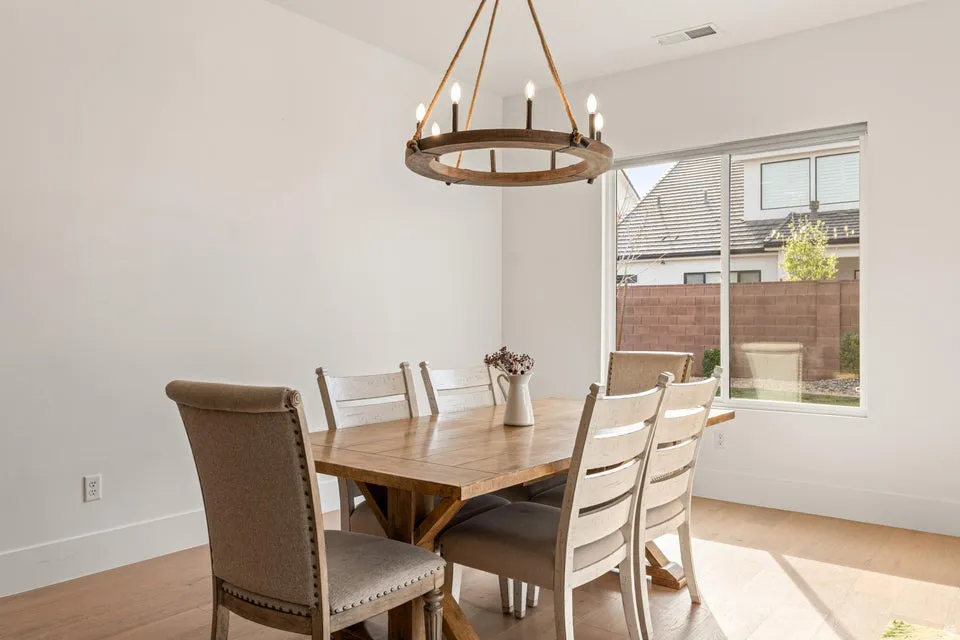 Dining room featuring light wood-style floors and suspended lighting
