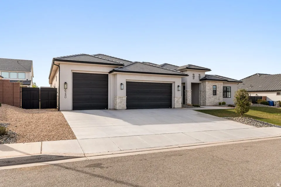 Prairie-style home with stucco siding, concrete driveway, and a garage