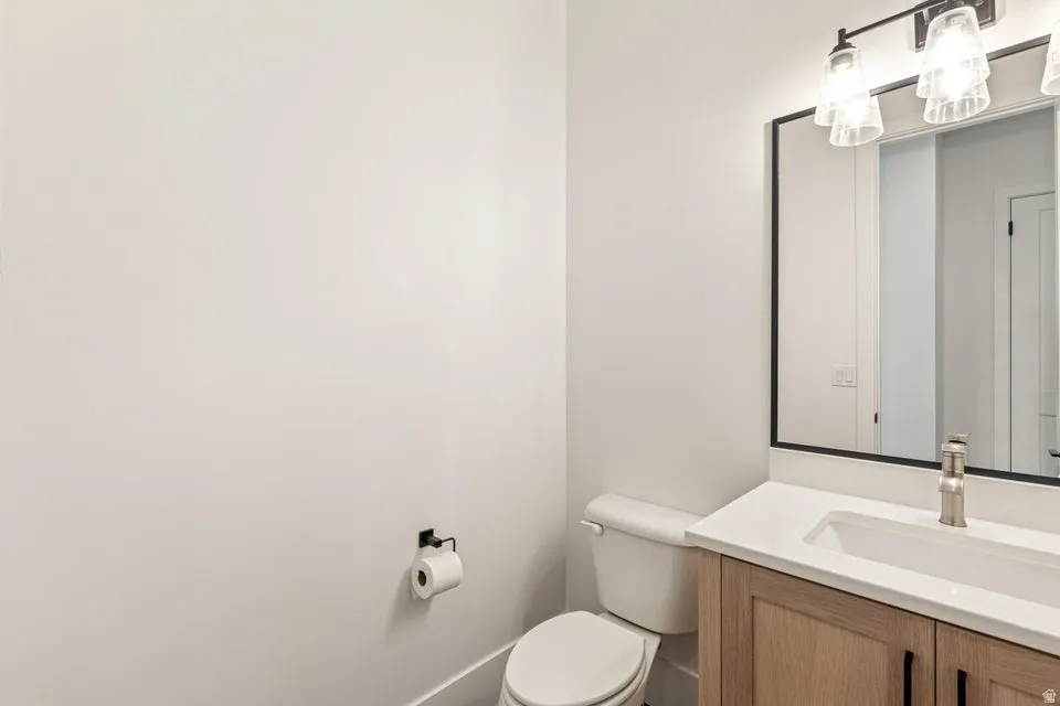 Half bath featuring vanity and toilet