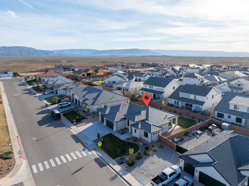 Aerial perspective of suburban area featuring a mountain backdrop