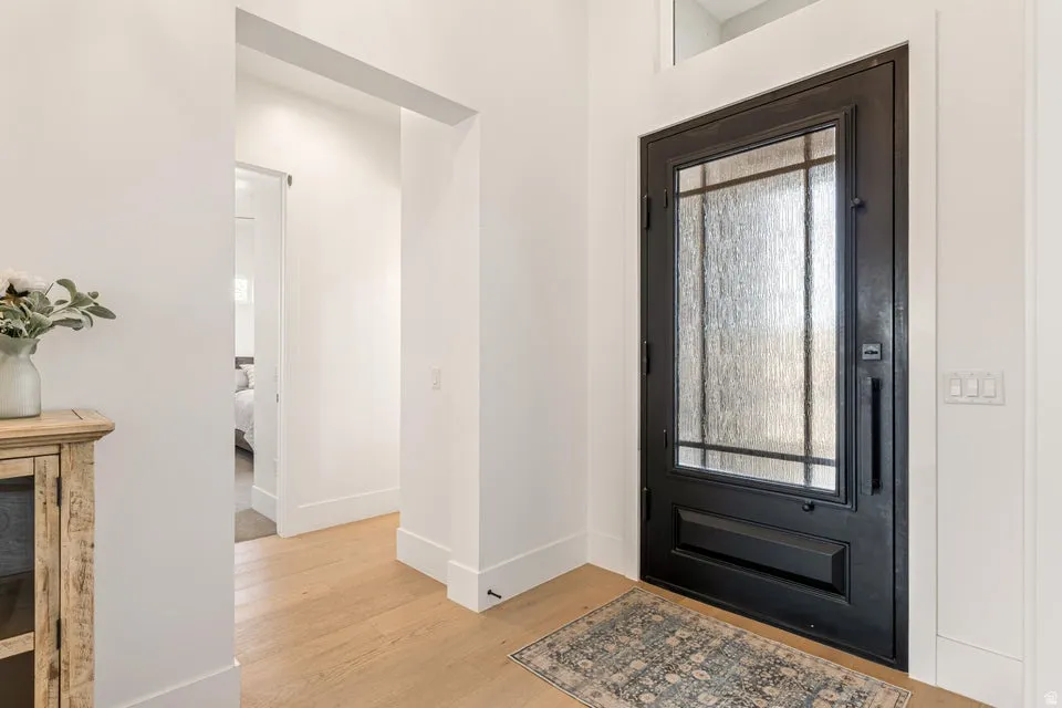 Foyer featuring baseboards and light wood finished floors