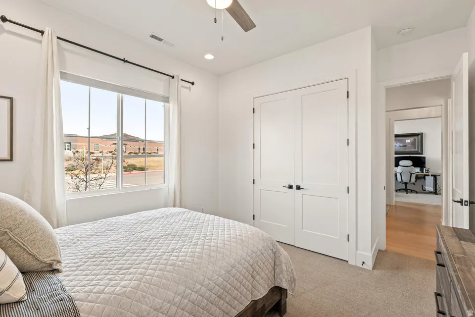Bedroom featuring light carpet, recessed lighting, ceiling fan, a closet, and an office area