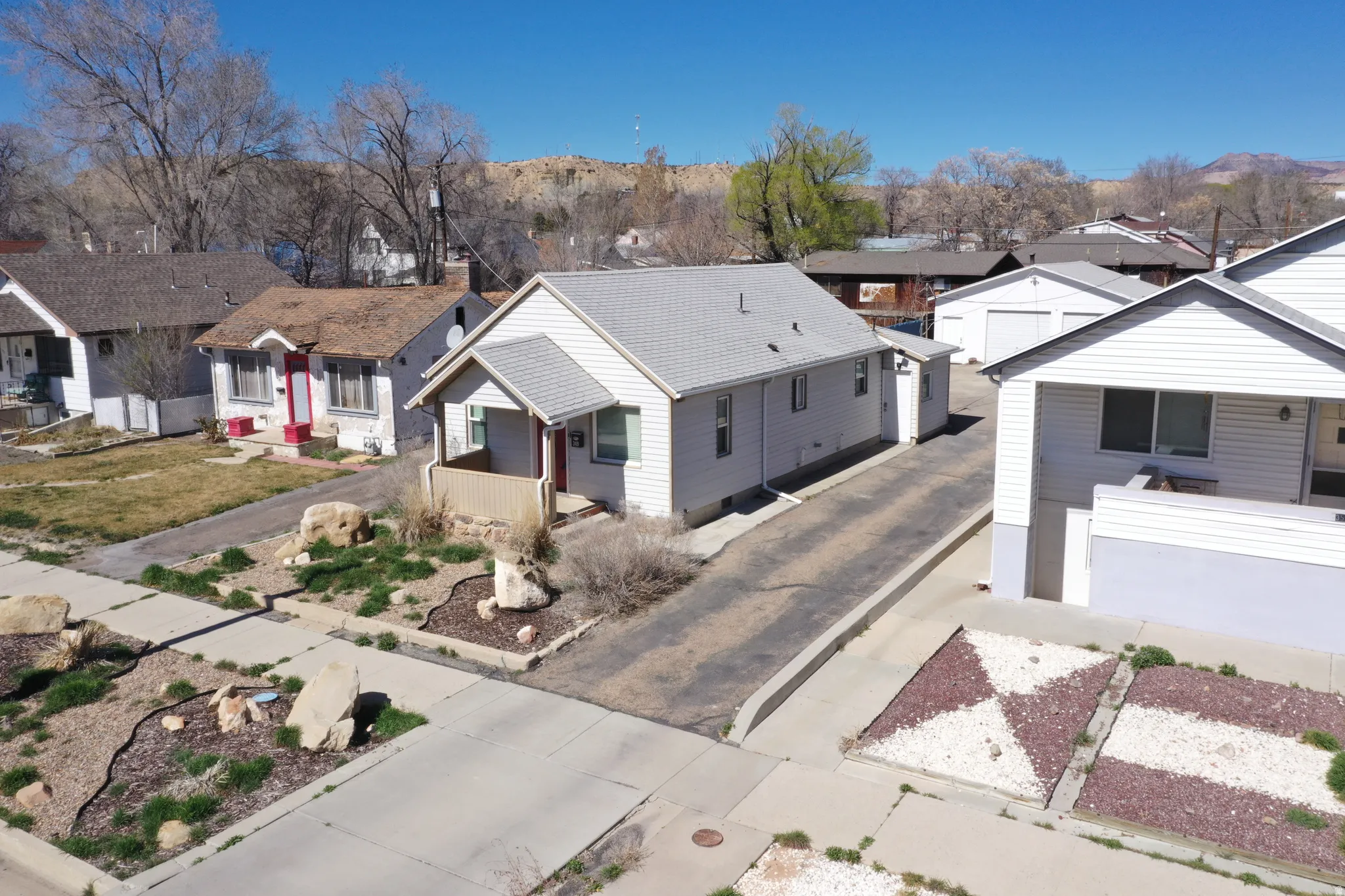 View of front facade featuring a residential view and driveway