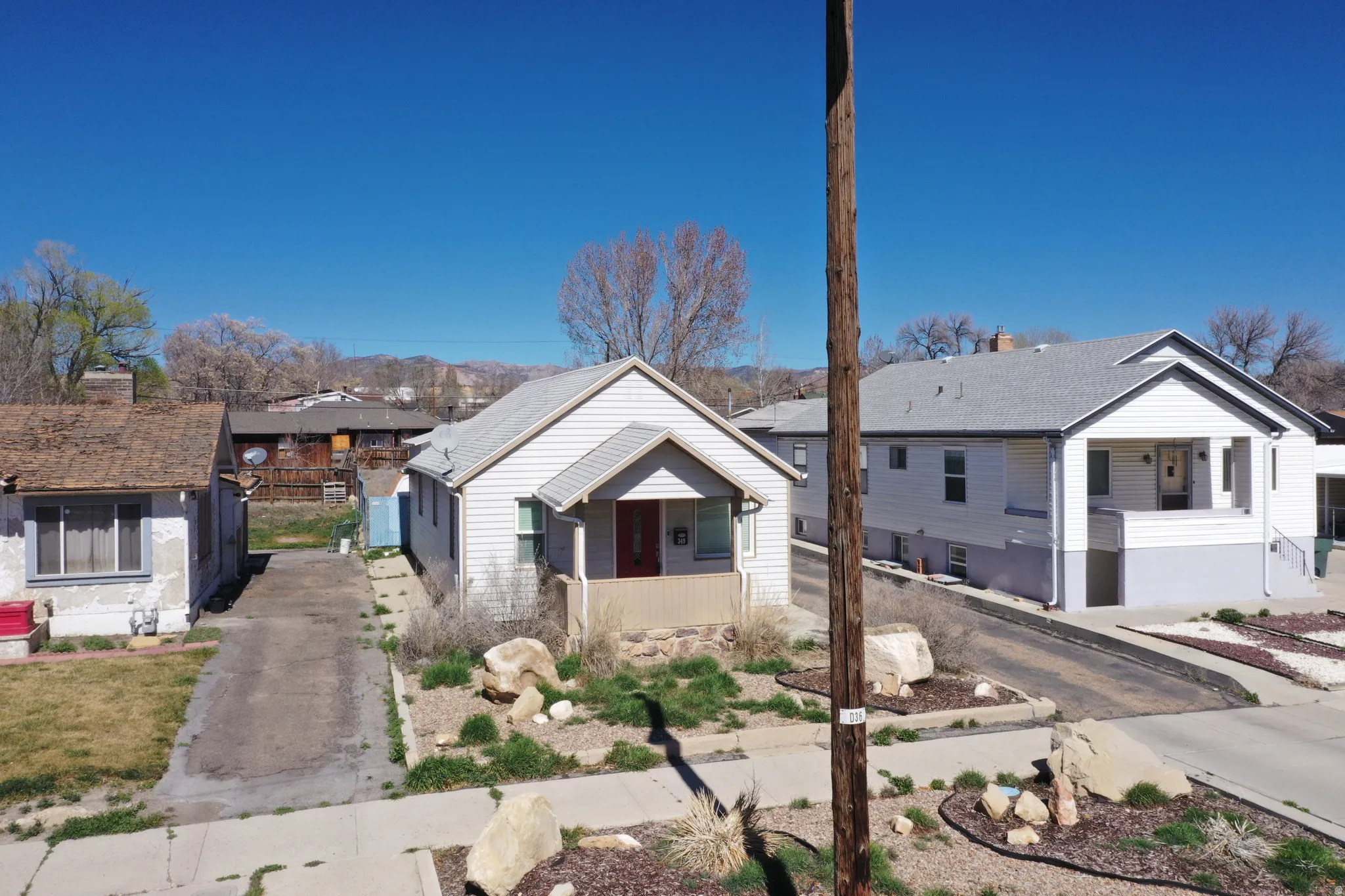 Bungalow with a residential view, covered porch, and driveway