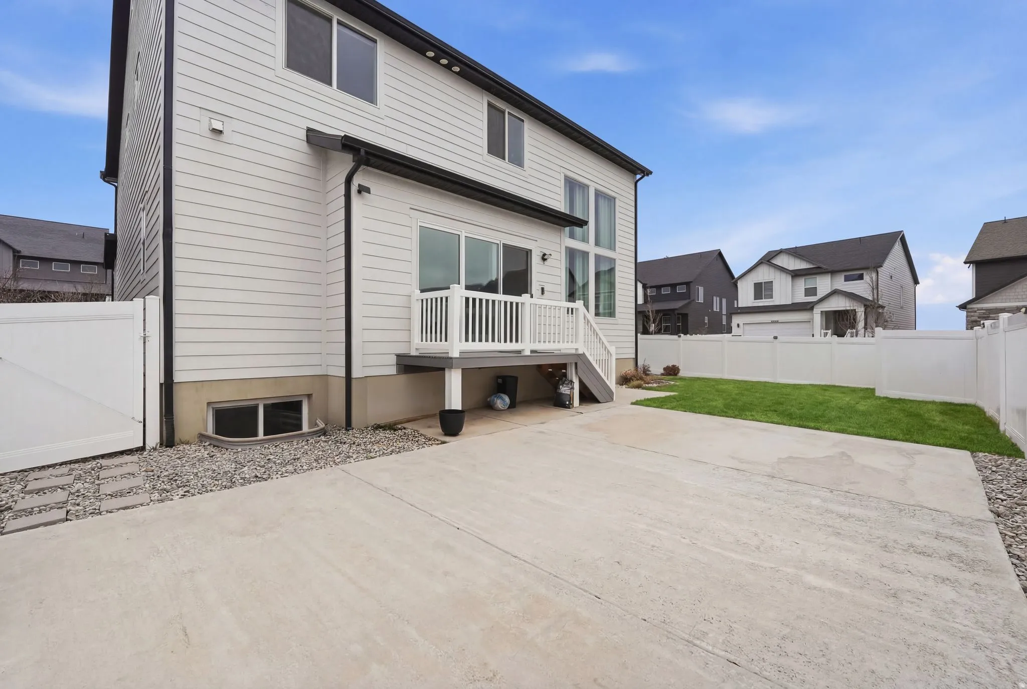 Rear view of property with a fenced backyard, a deck, a gate, and a residential view