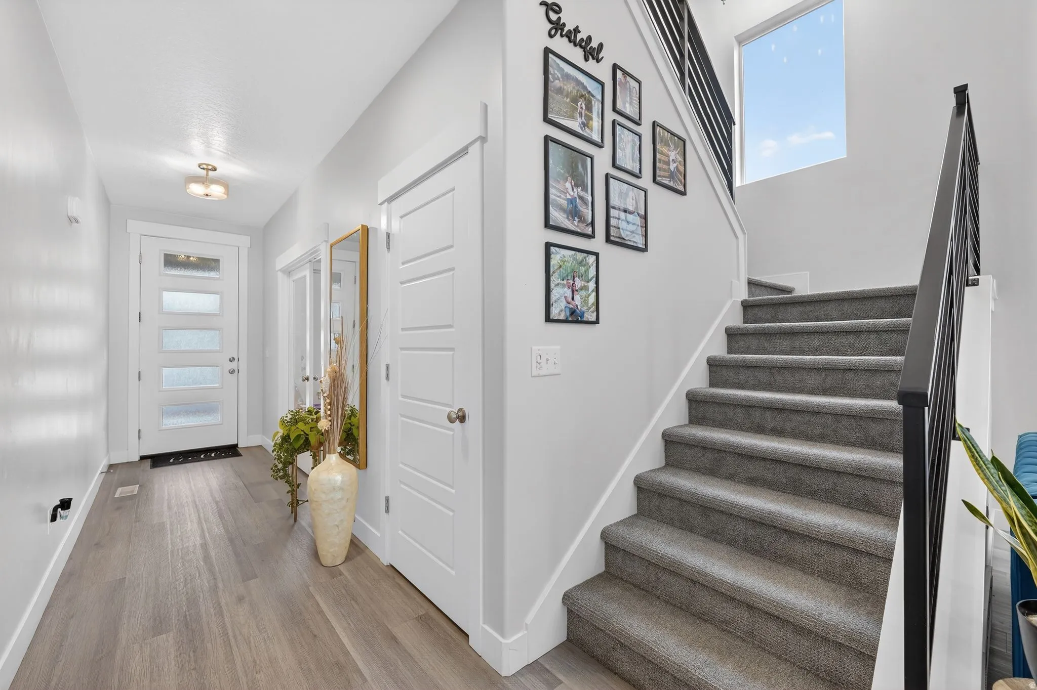 Entrance foyer with light wood-type flooring and plenty of natural light