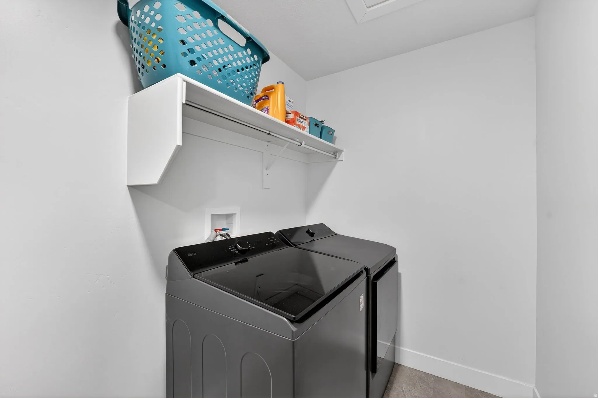 Laundry room featuring washer and dryer and baseboards