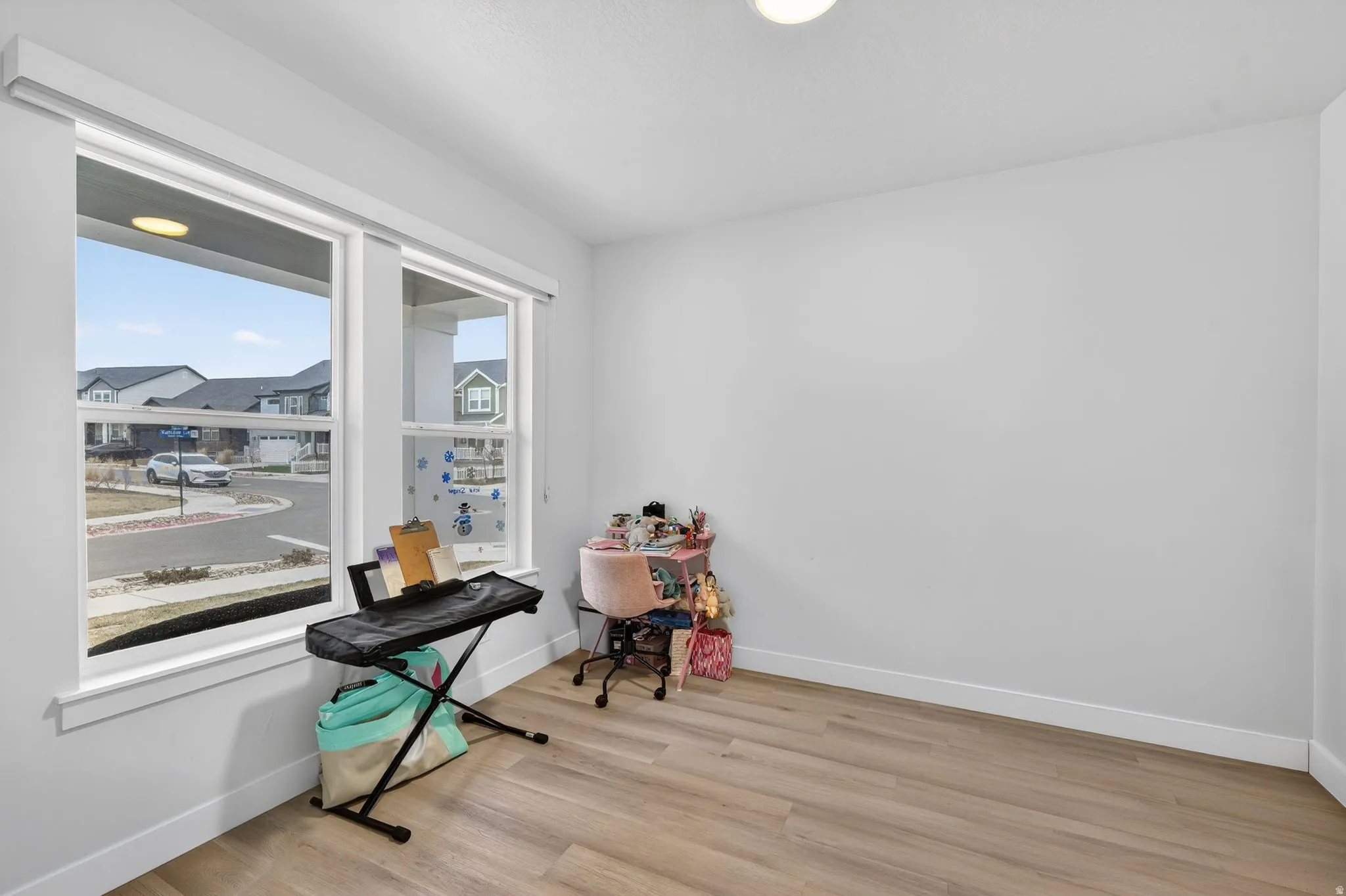 Miscellaneous room with light wood finished floors and baseboards