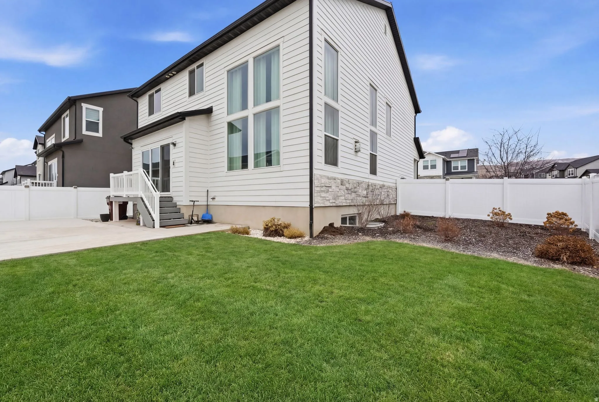 Rear view of house with a fenced backyard