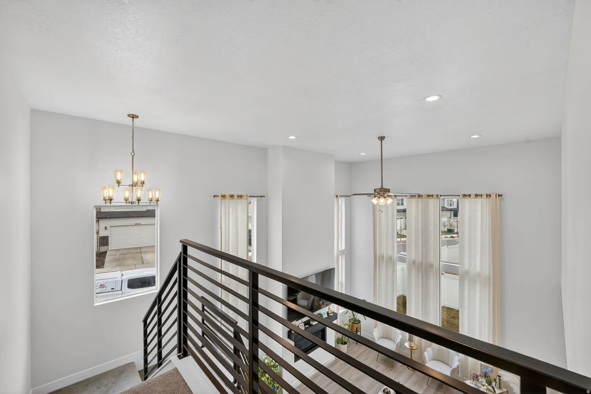 Hall featuring an upstairs landing and suspended lighting