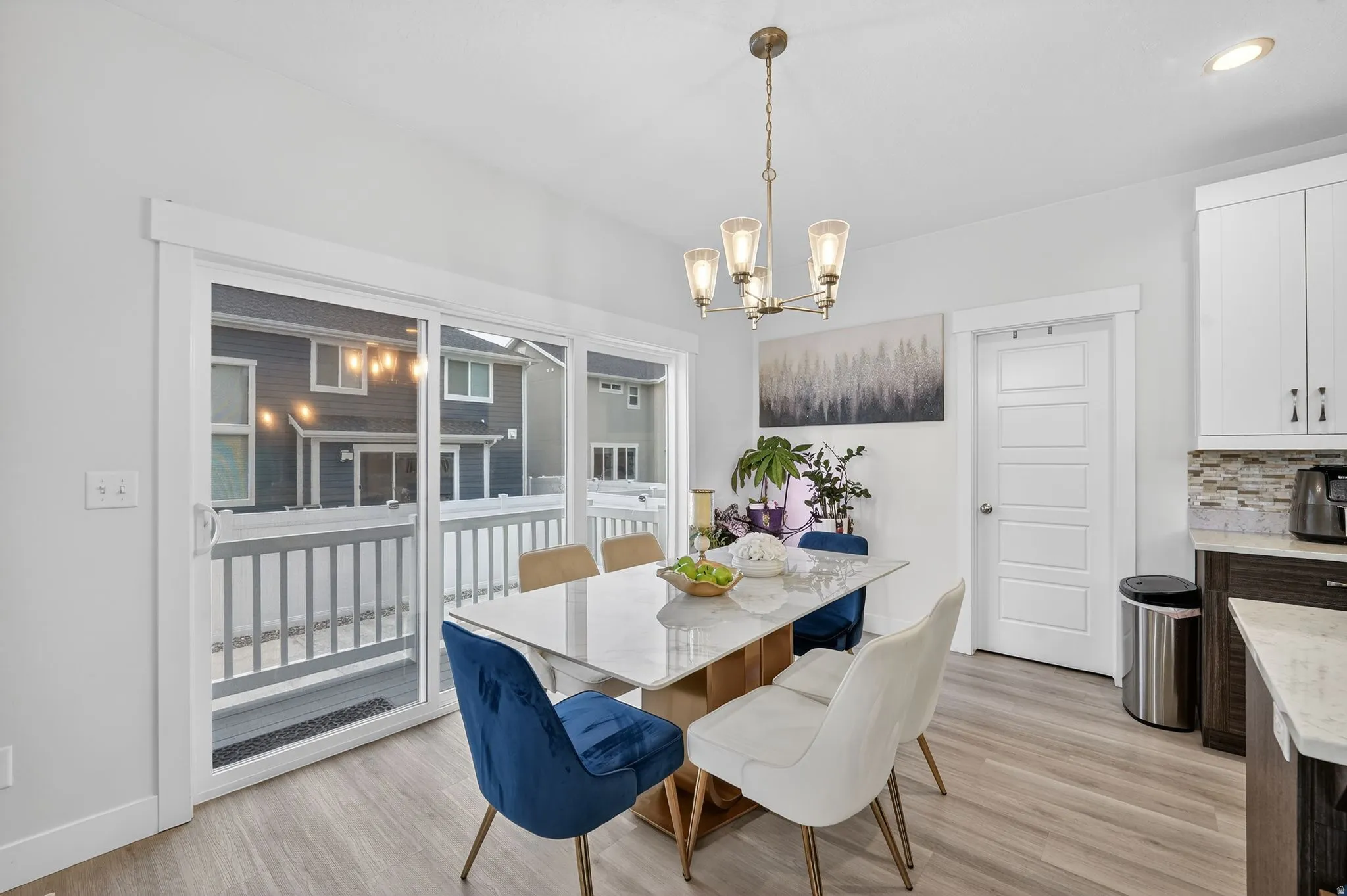 Dining space featuring light wood-type flooring and suspended lighting