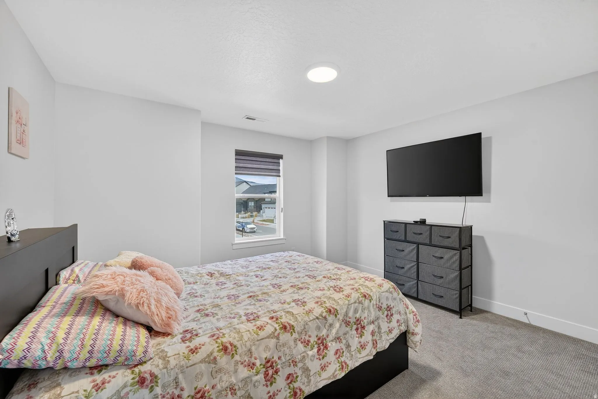 Bedroom featuring light carpet and baseboards