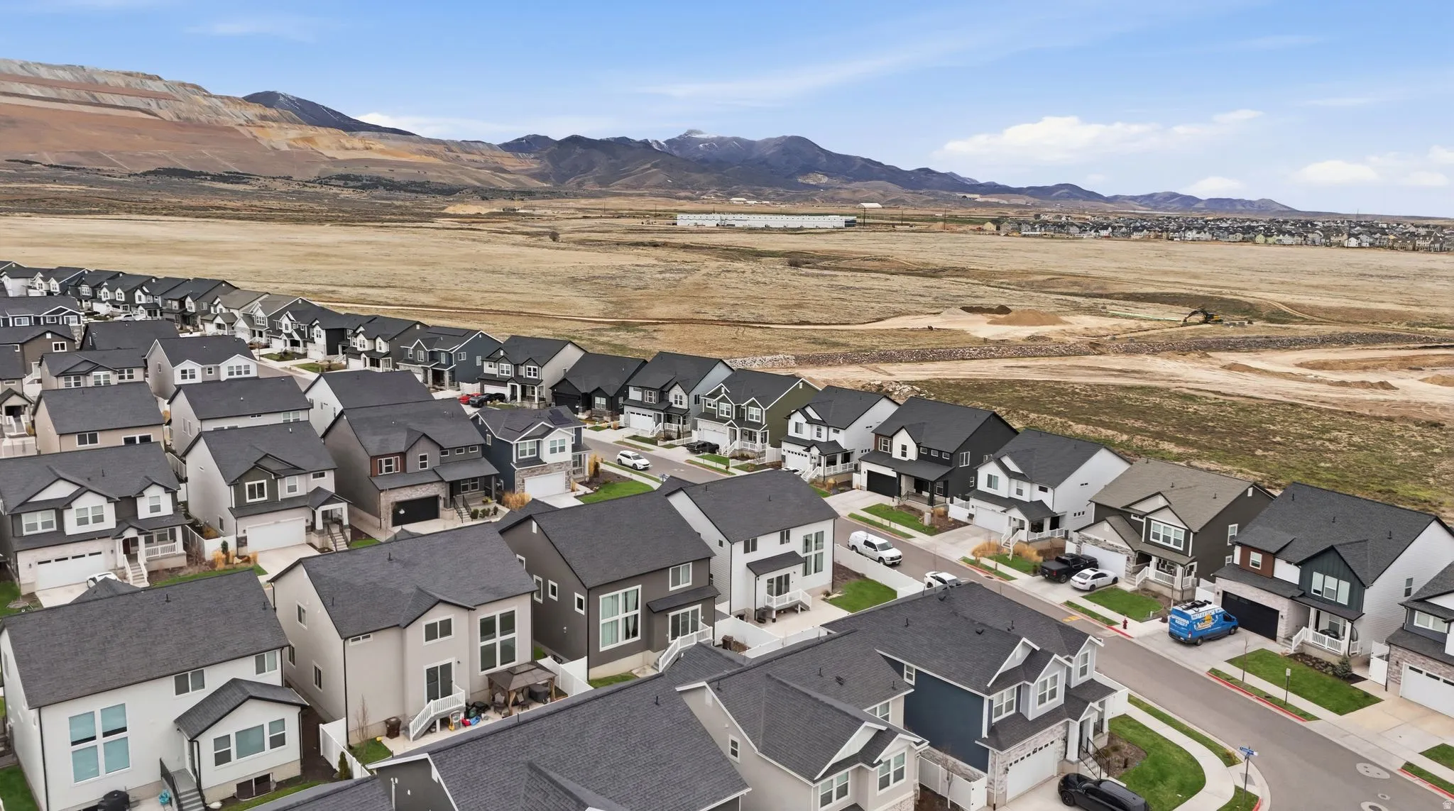 Aerial perspective of suburban area with a mountainous background