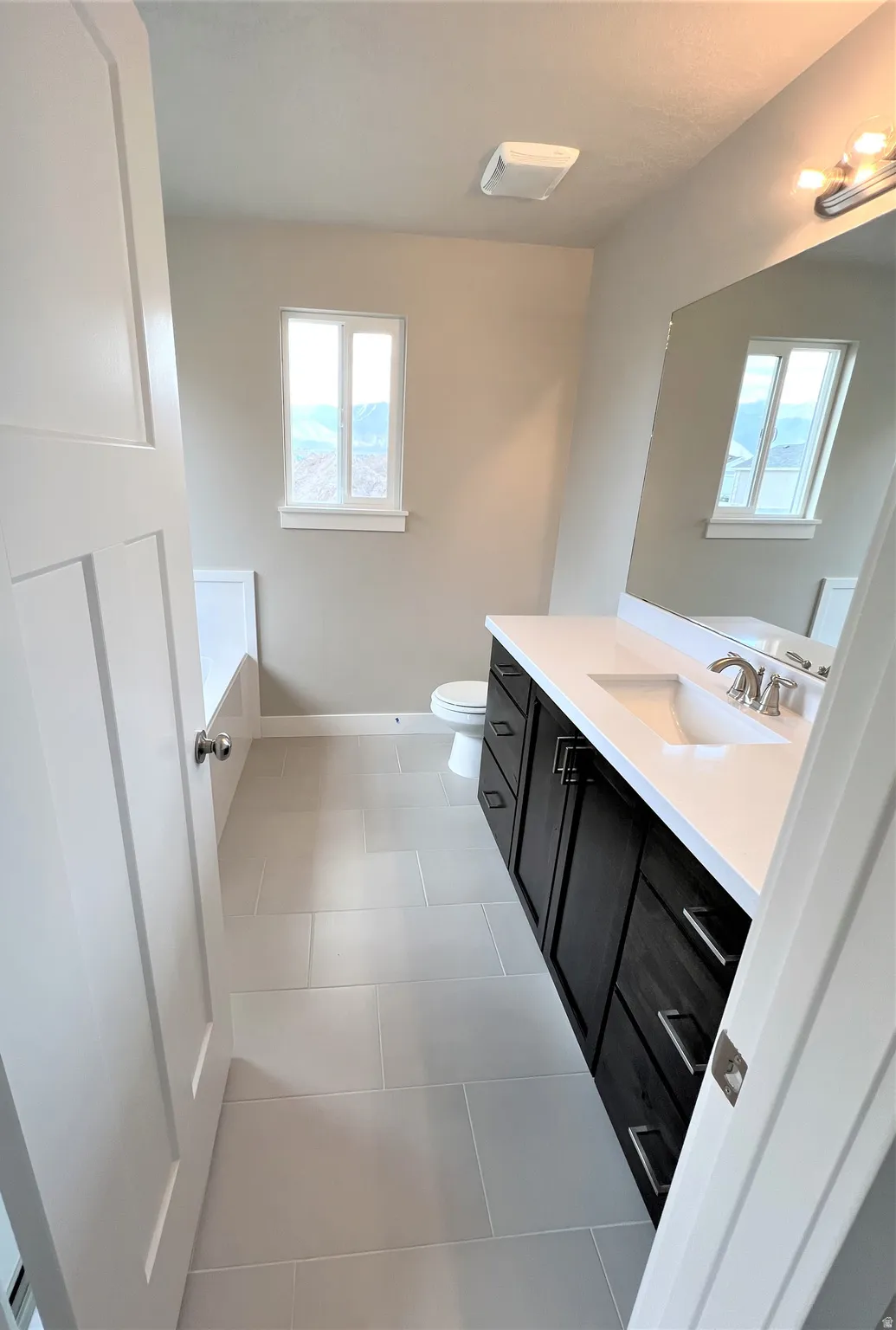 Bathroom featuring vanity and light tile patterned flooring