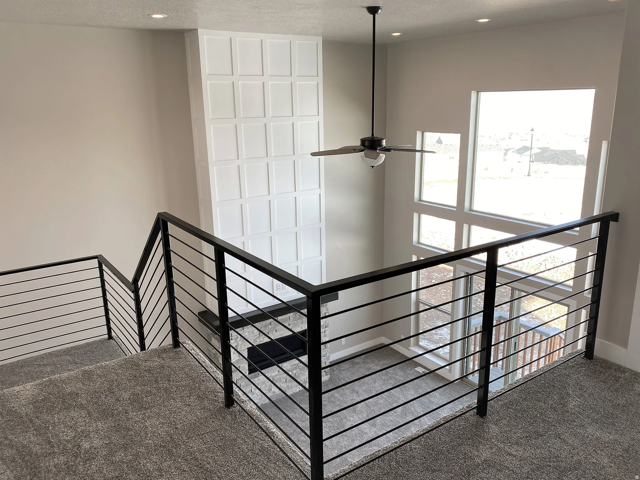 Stairway with carpet, a ceiling fan, and recessed lighting