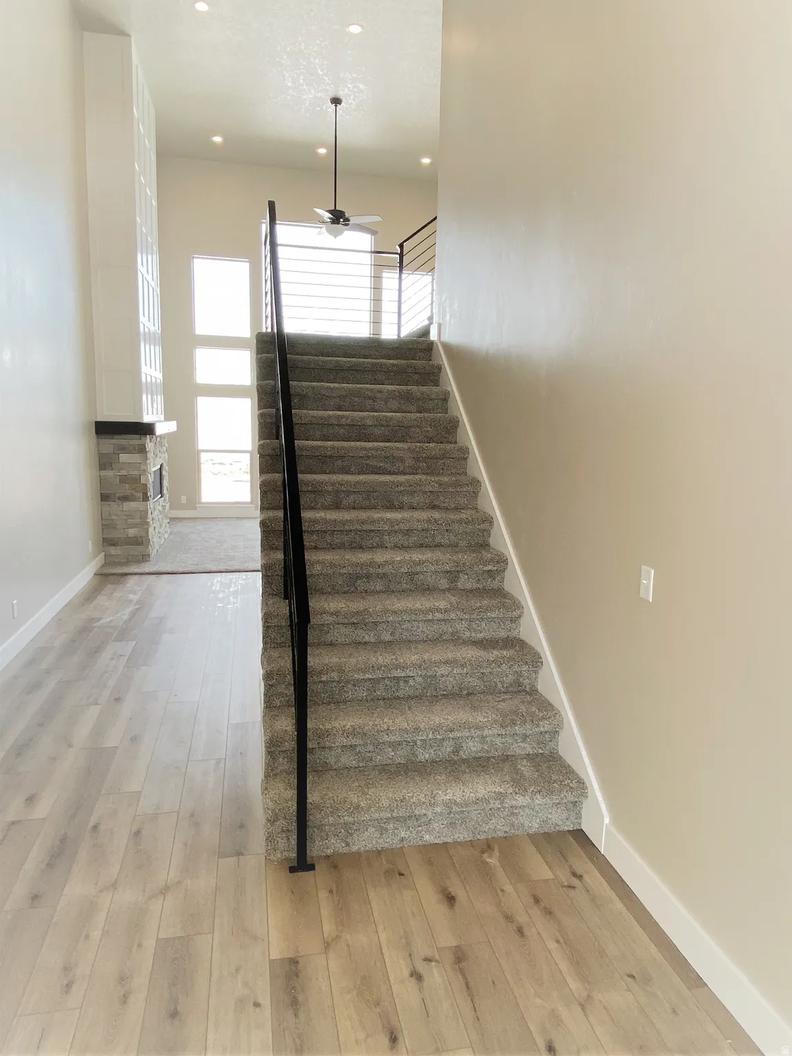 Stairway with hardwood / wood-style flooring, recessed lighting, and a ceiling fan