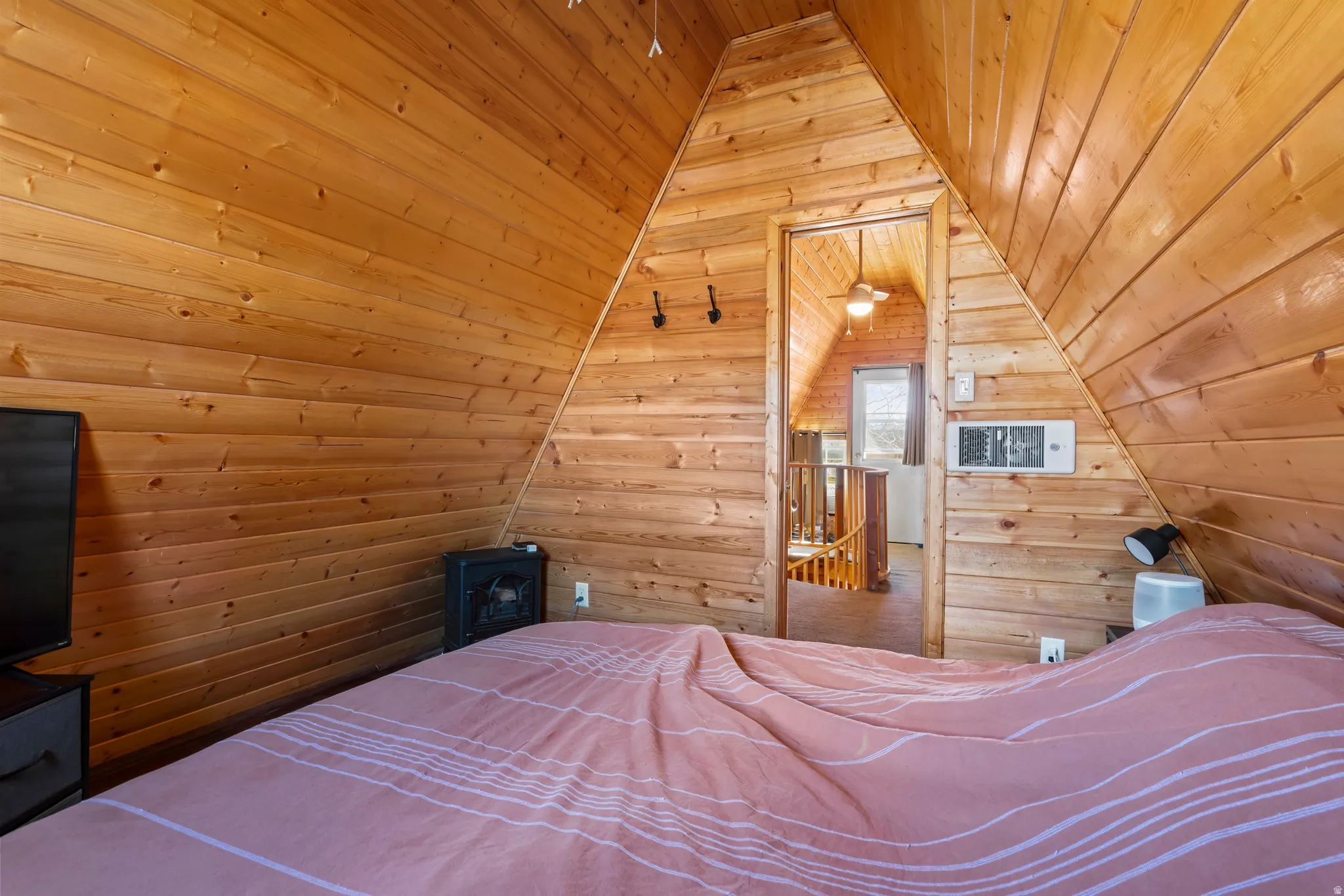 Bedroom with a vaulted wood ceiling
