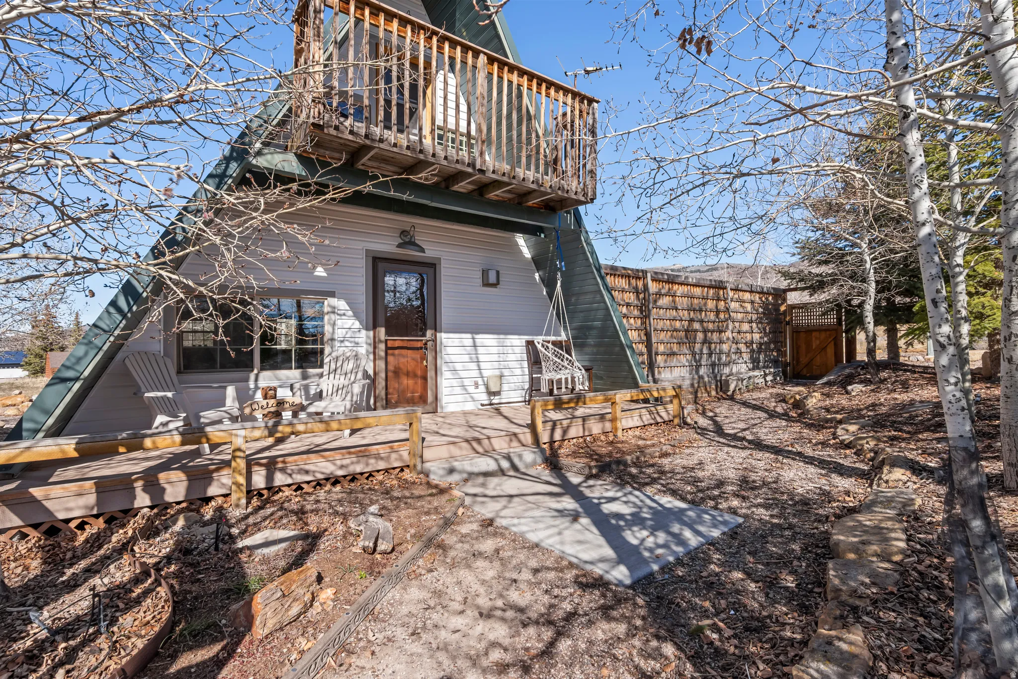 Front of house featuring a deck & balcony