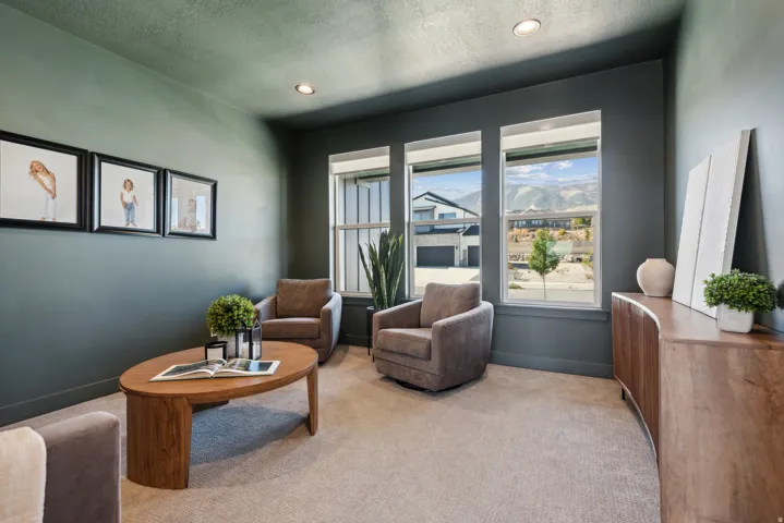Living area featuring carpet flooring, recessed lighting, a textured ceiling, and a mountain view