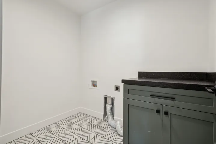 Laundry room with electric dryer hookup, washer hookup, and cabinet space