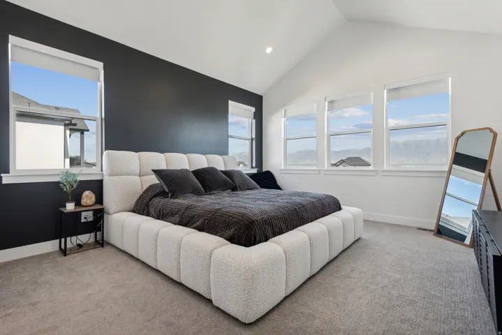 Bedroom with light colored carpet and recessed lighting