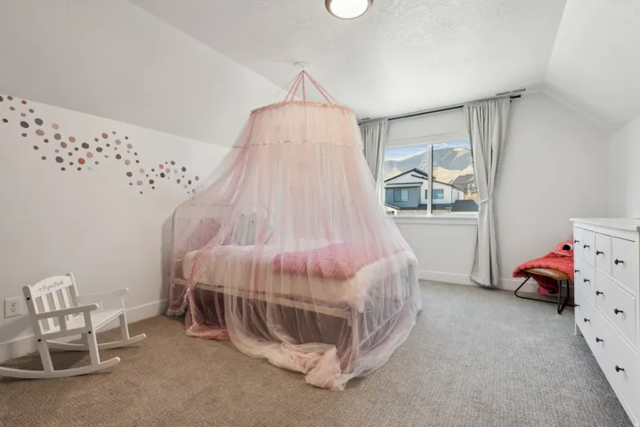 Bedroom featuring light carpet and baseboards