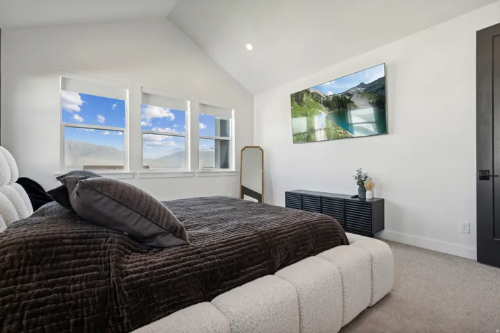 Bedroom featuring carpet floors, vaulted ceiling, and recessed lighting