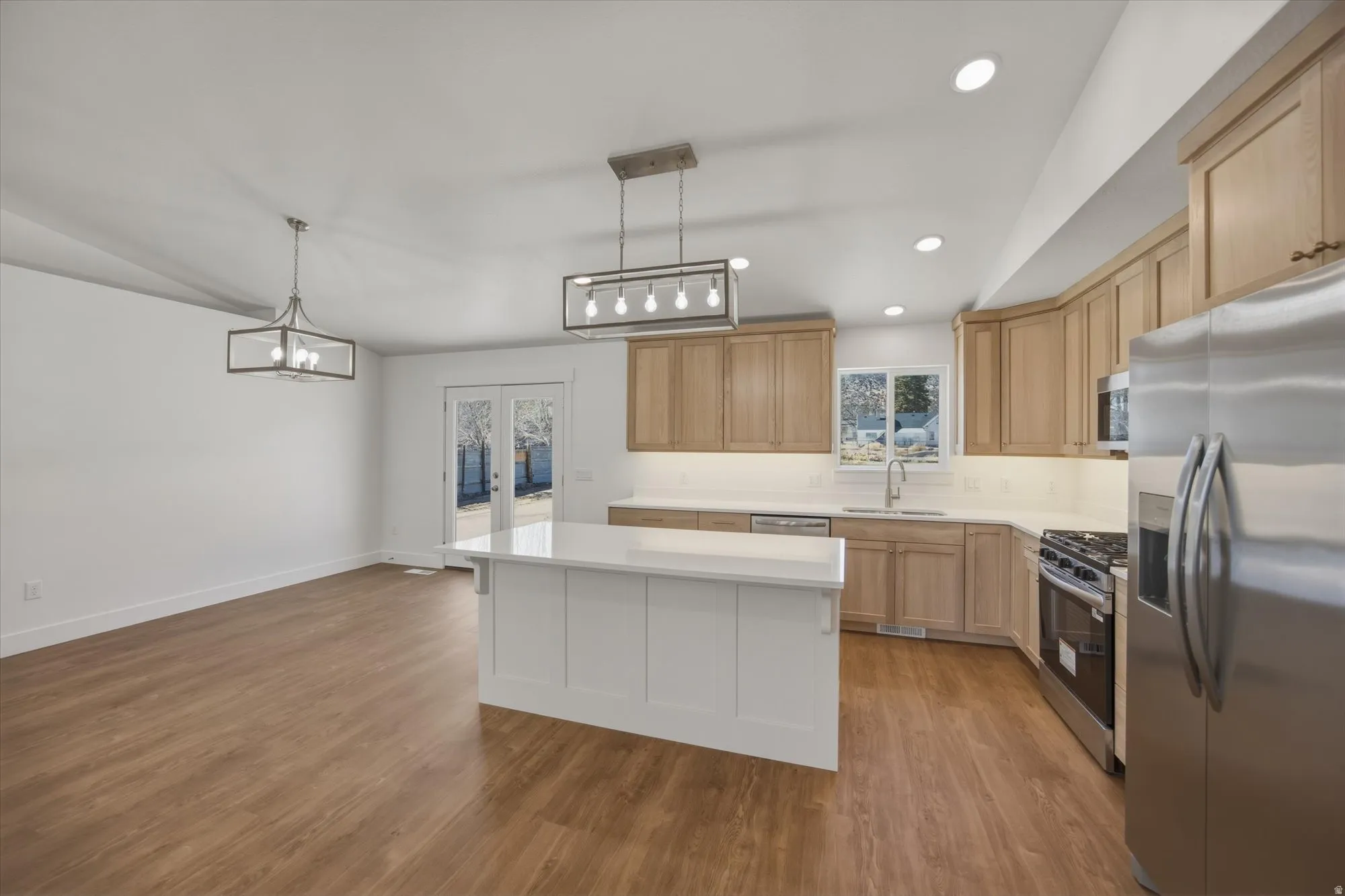 Kitchen features white oak cabinets, stainless steel appliances