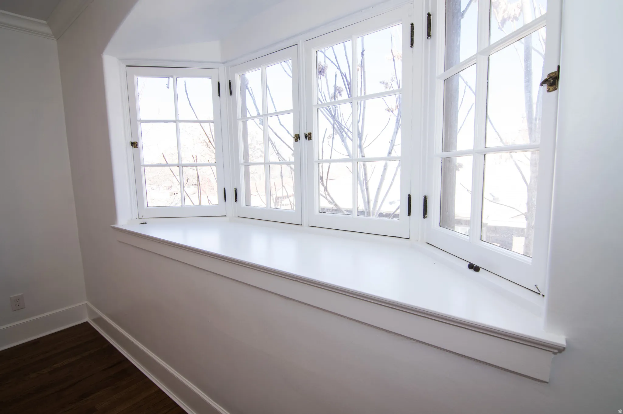 Detailed view of baseboards and wood finished floors
