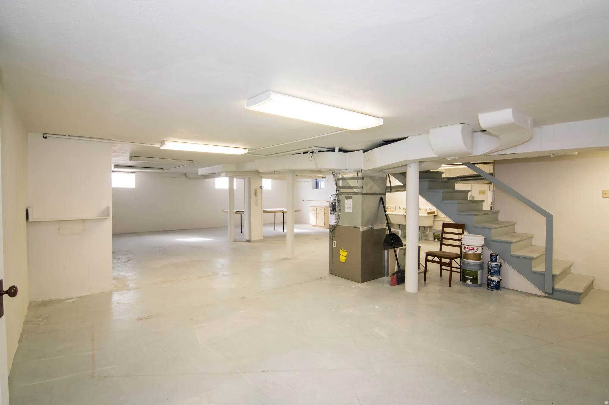 Basement featuring stairs and heating unit