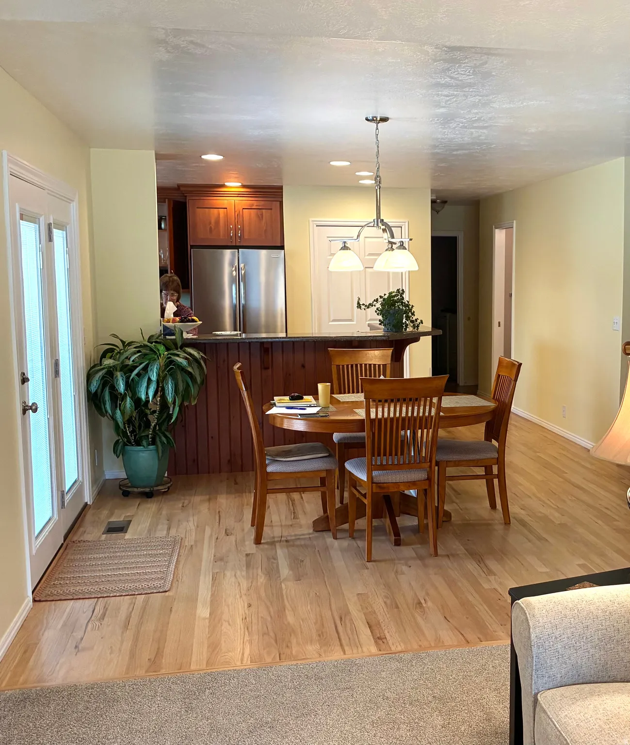 Dining room with light wood finished floors and recessed lighting
