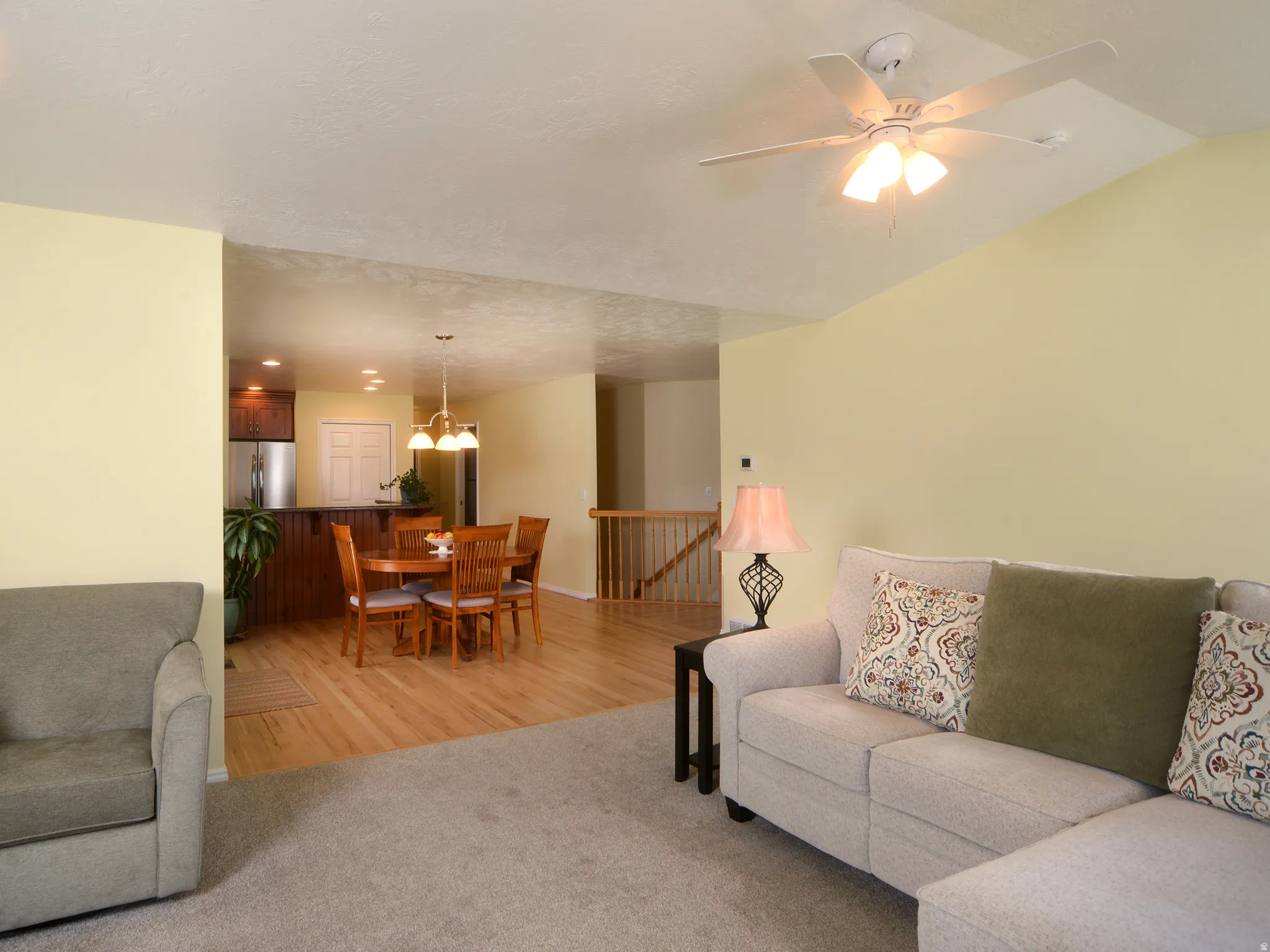 Living room featuring light carpet and ceiling fan