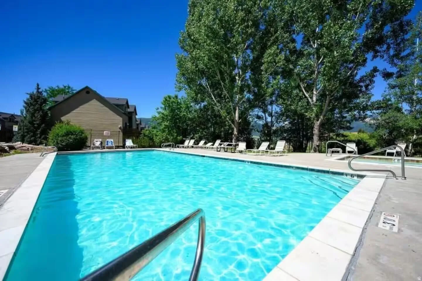 Community pool with a patio