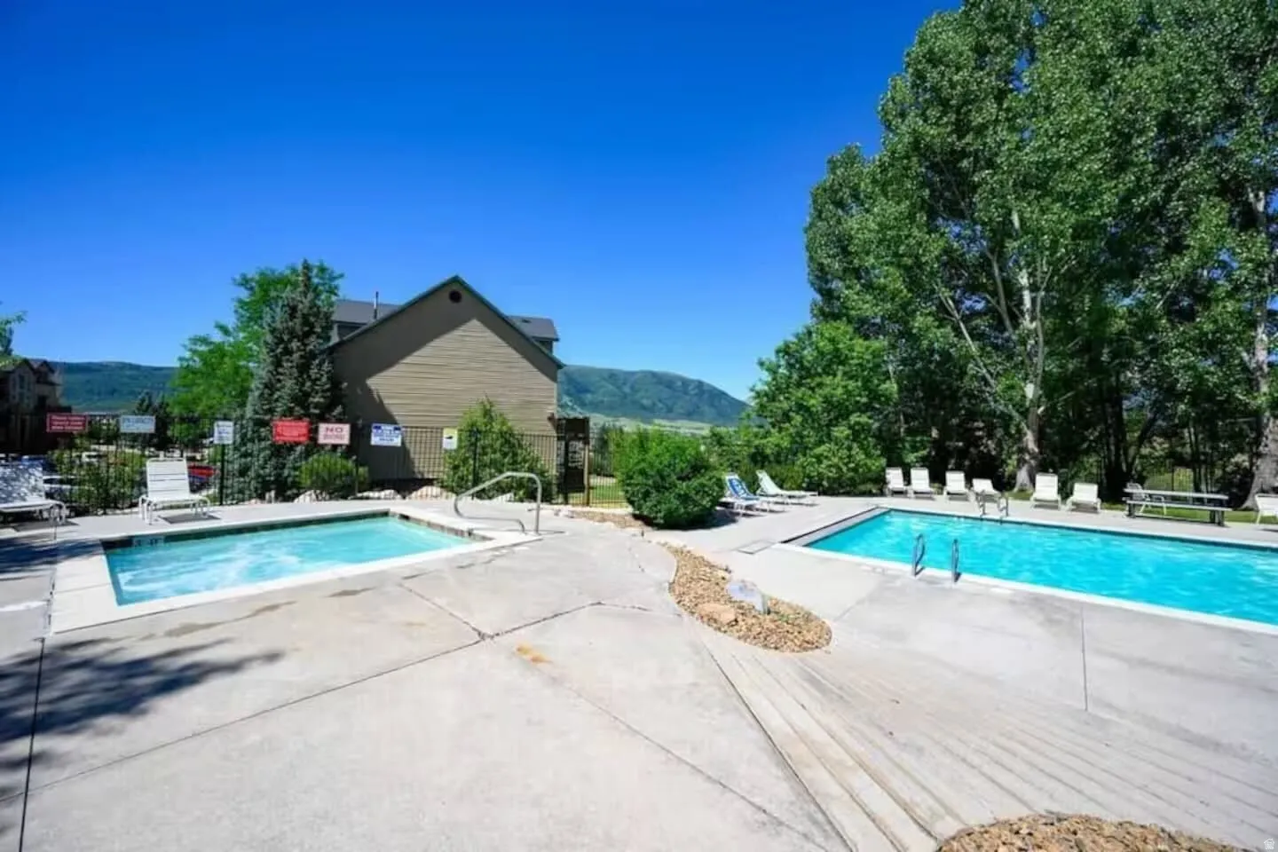 Community pool featuring a patio area and a mountain view