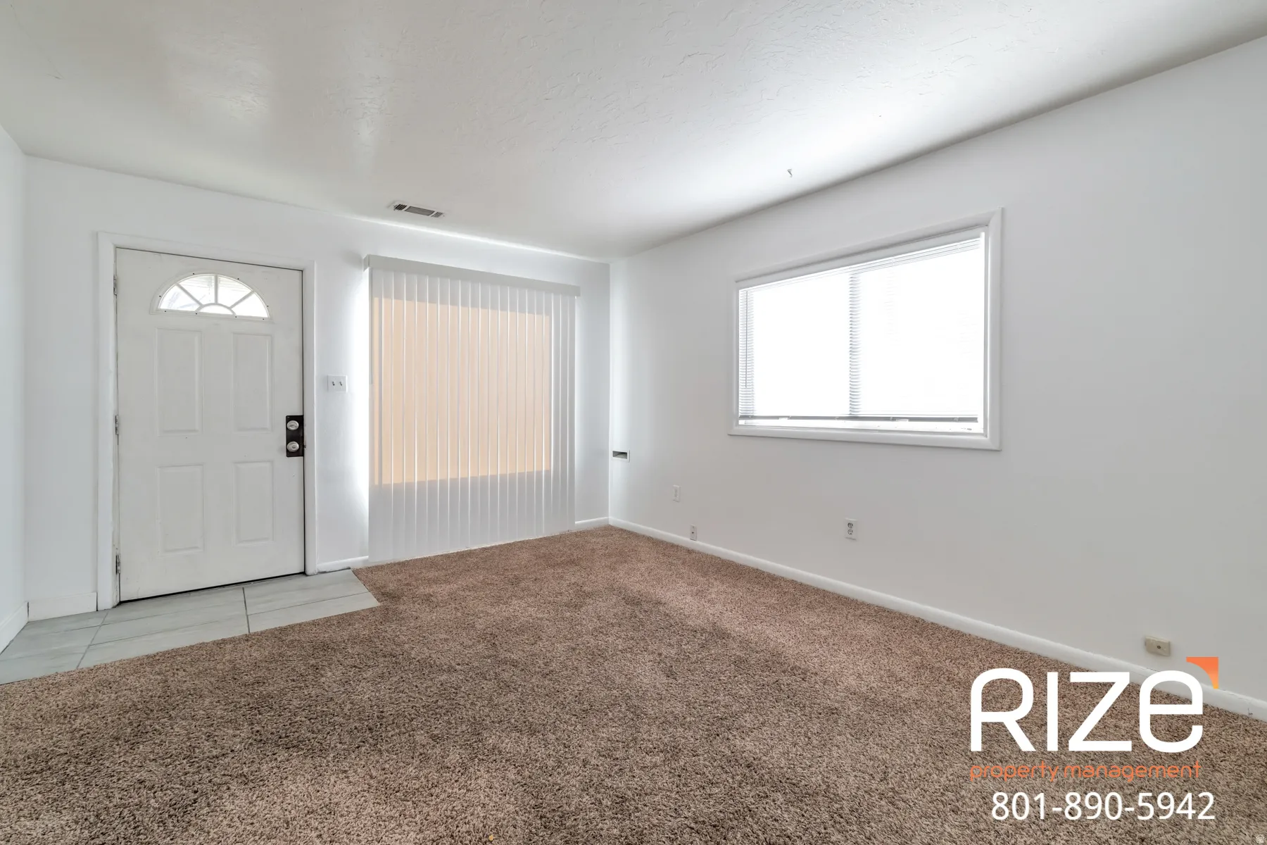 Entrance foyer with light colored carpet and baseboards