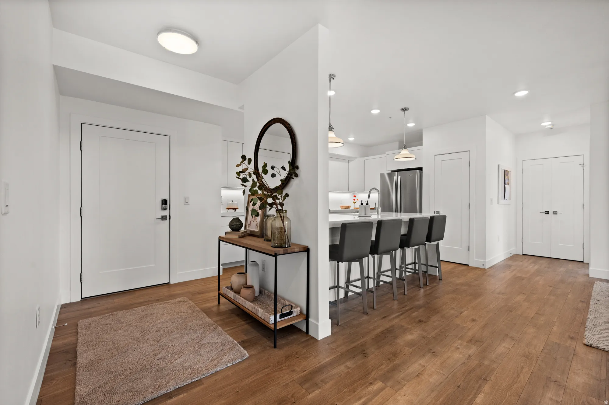 Entrance foyer with dark wood-style floors and recessed lighting