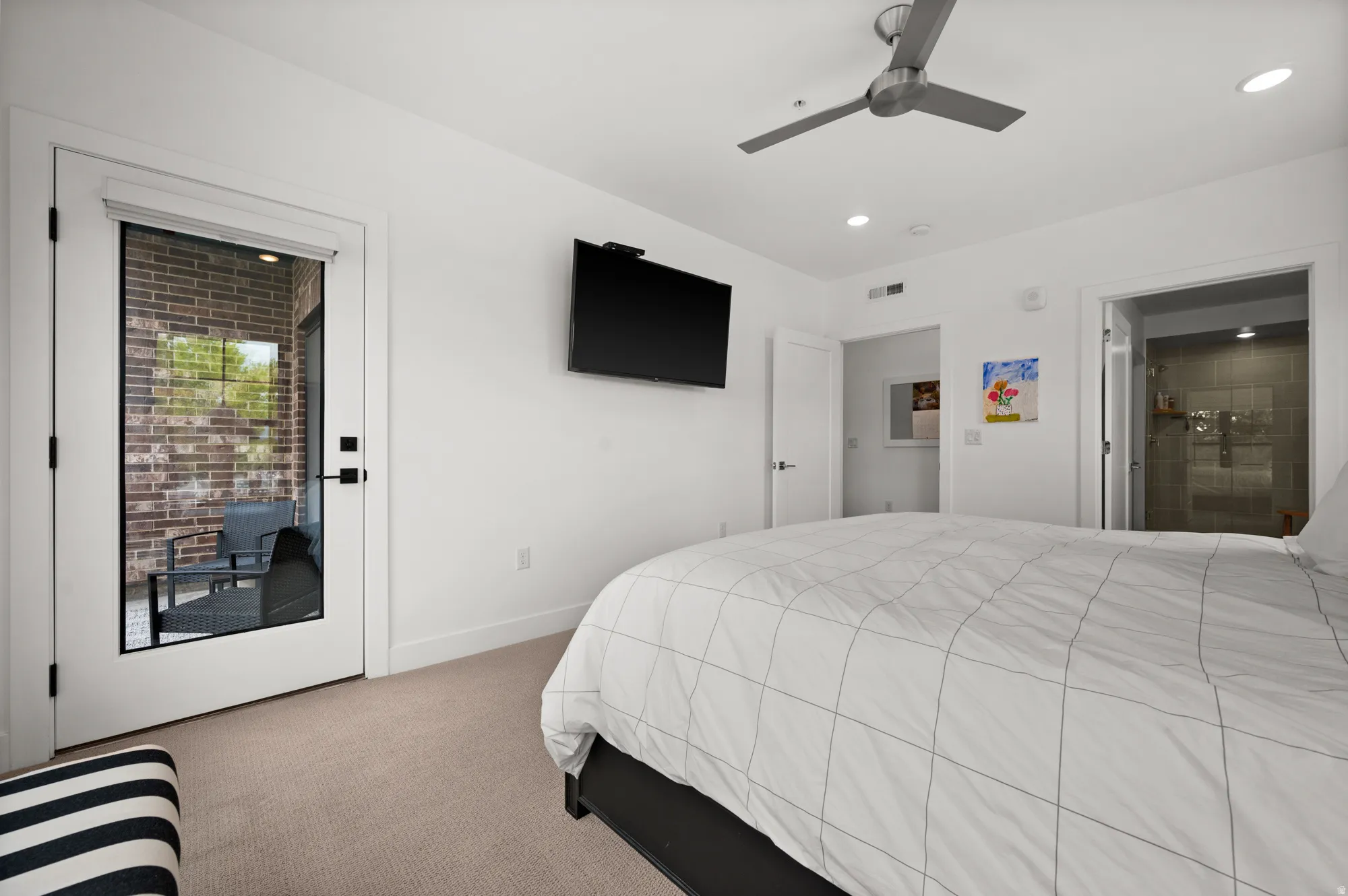 Bedroom with access to exterior, carpet flooring, and a ceiling fan