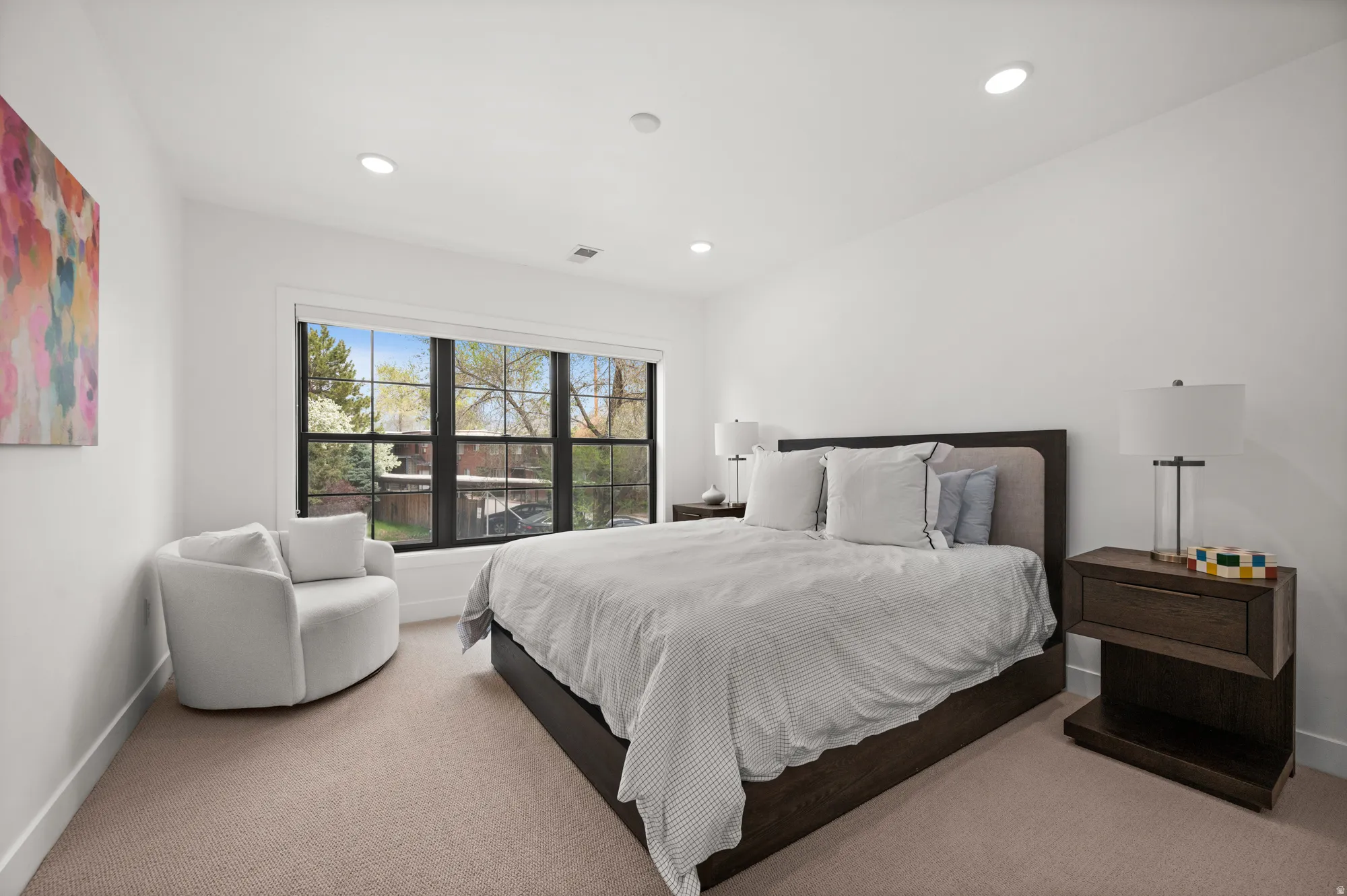 Bedroom with light carpet and recessed lighting