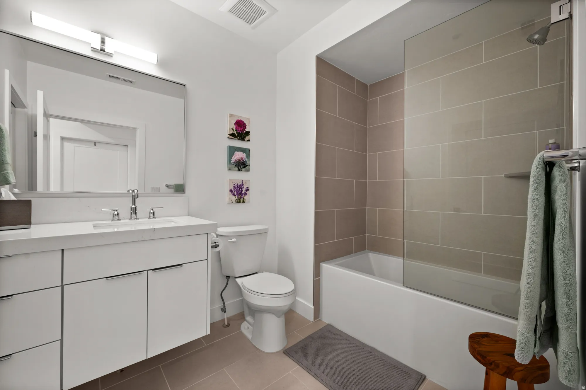 Full bathroom featuring vanity, light tile patterned floors, and shower / bathtub combination