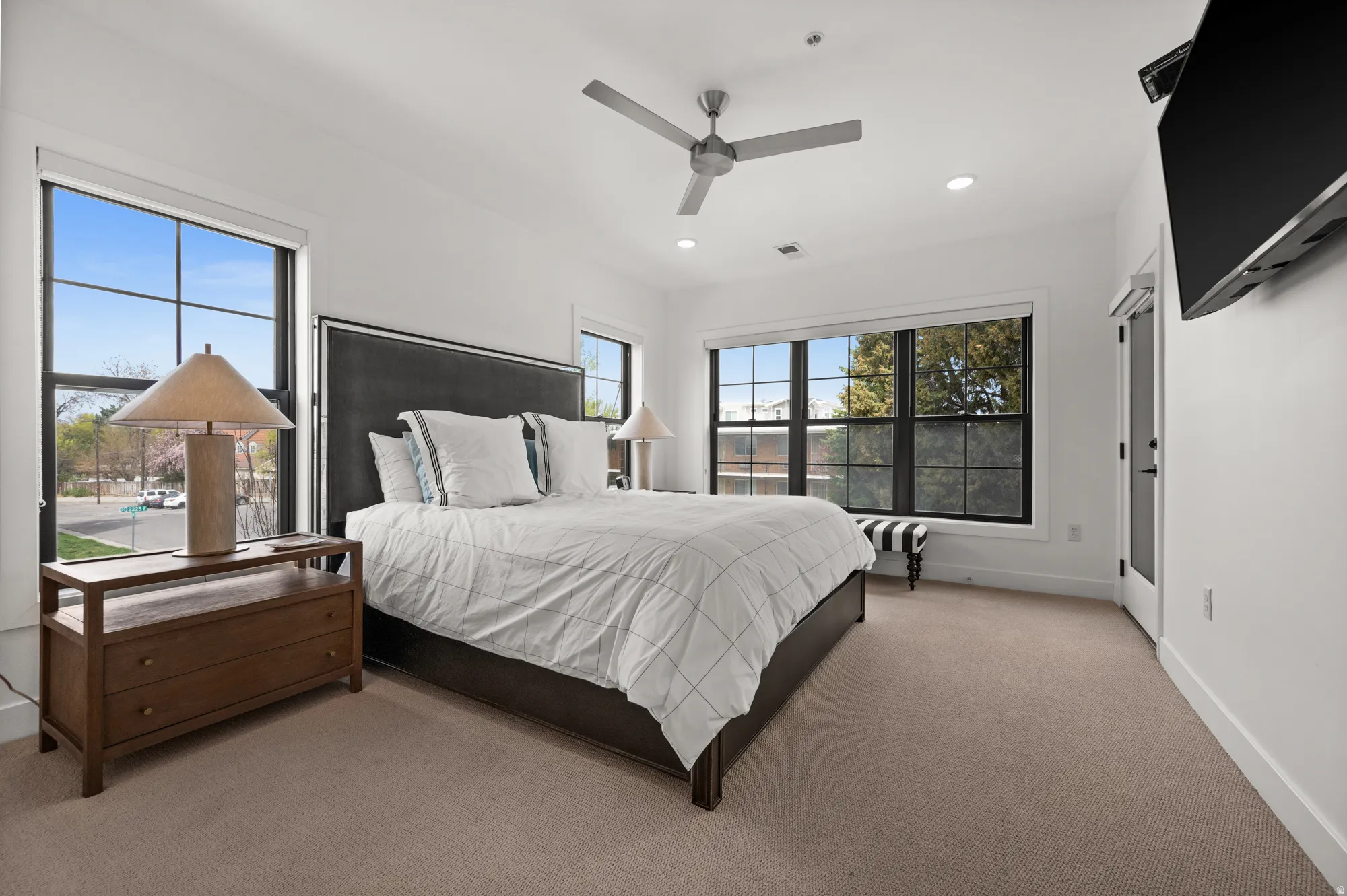 Bedroom featuring light colored carpet, a ceiling fan, and recessed lighting