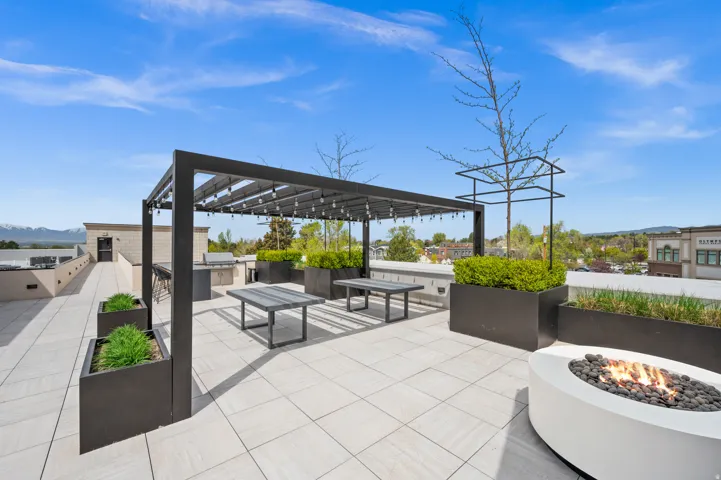 View of patio featuring exterior kitchen, a fire pit, a mountain view, and a pergola