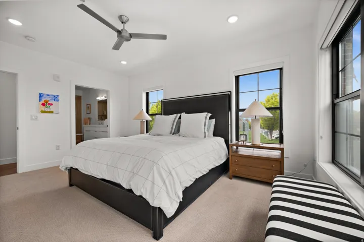 Bedroom featuring light colored carpet, ceiling fan, and recessed lighting