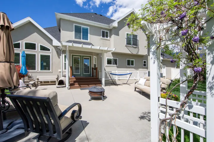 Expansive concrete patio with direct access to the interior via double French doors