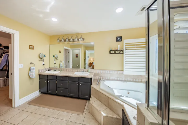 Bathroom featuring a dual vanity with dark wood cabinetry and integrated sinks
