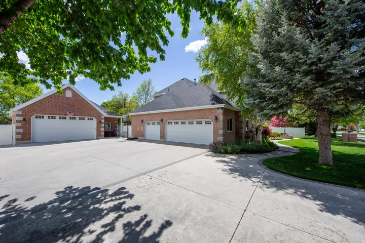 Expansive concrete driveway servicing multiple garage doors