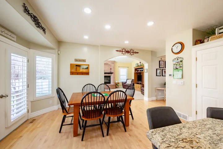 Dining area featuring wood-finish flooring and recessed lighting