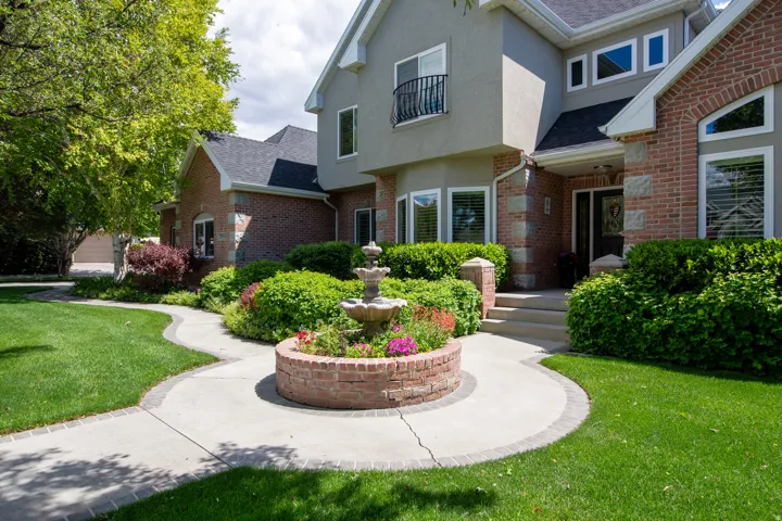 Brick and stucco exterior with multiple gables and a covered front entry
