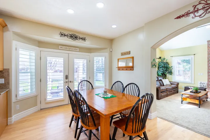 Dining area featuring wood-finish flooring, recessed lighting, and a bay window with plantation shutters