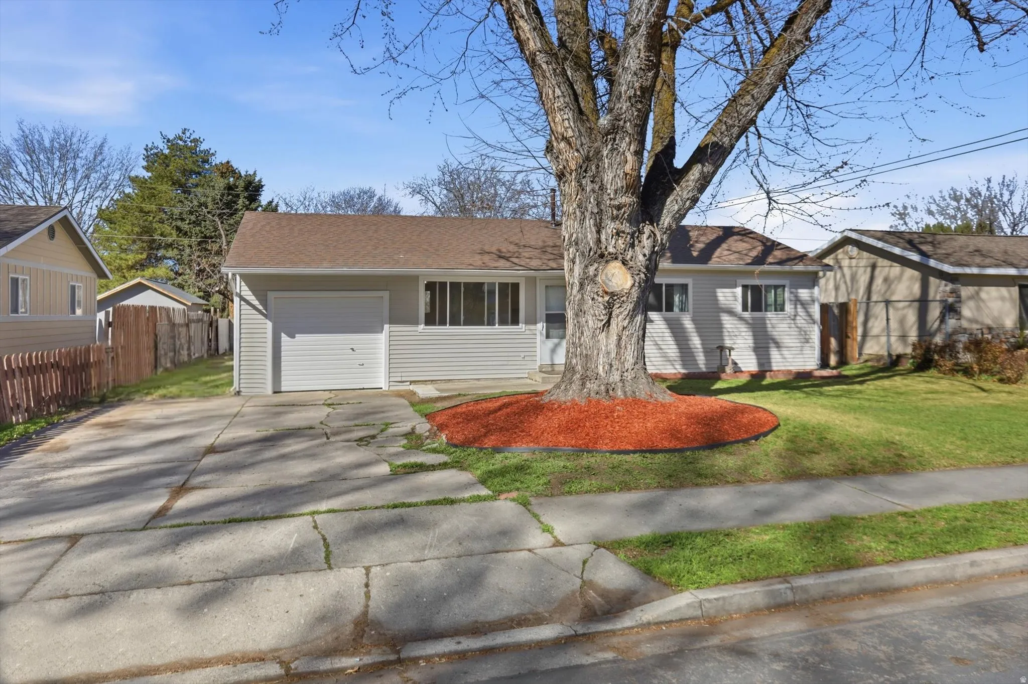 Ranch-style house with concrete driveway and an attached garage
