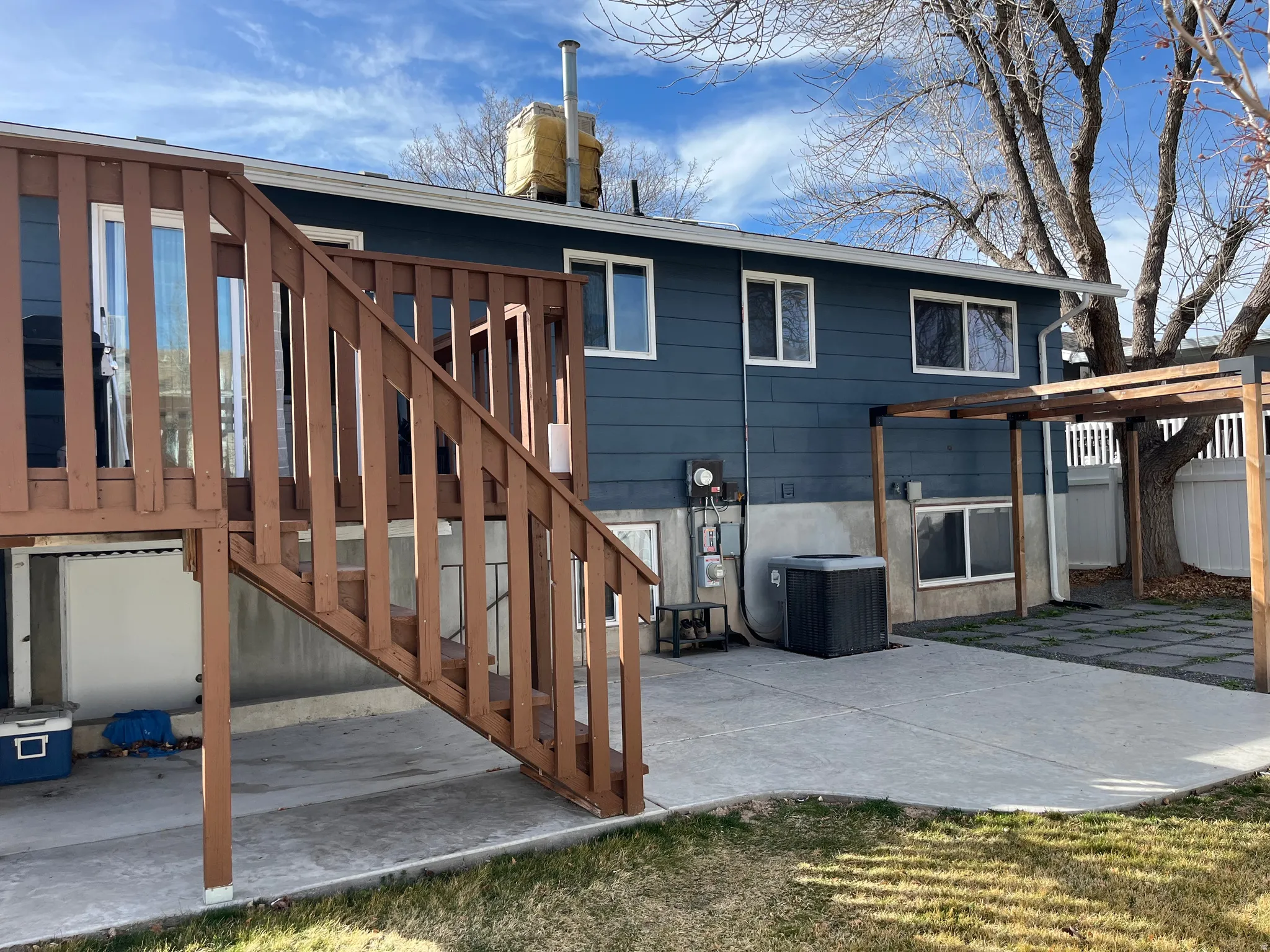 Rear view of house with a patio and a chimney